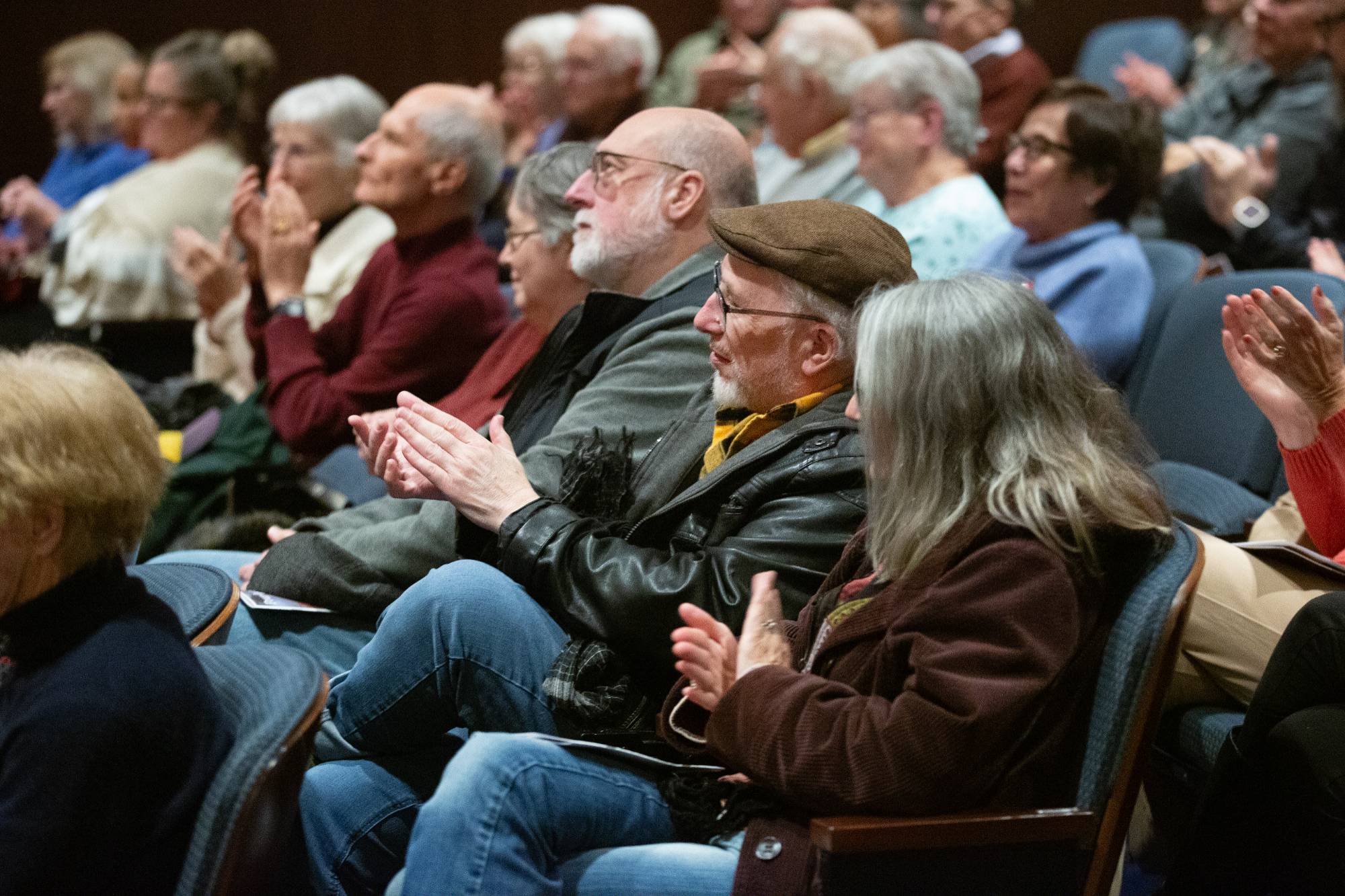 two people sitting on stage